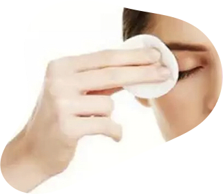 woman dubbing her eyelids with cotton