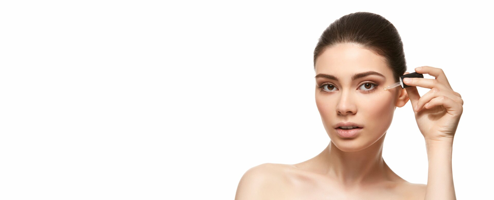woman putting eyebrow enhancing growth serum